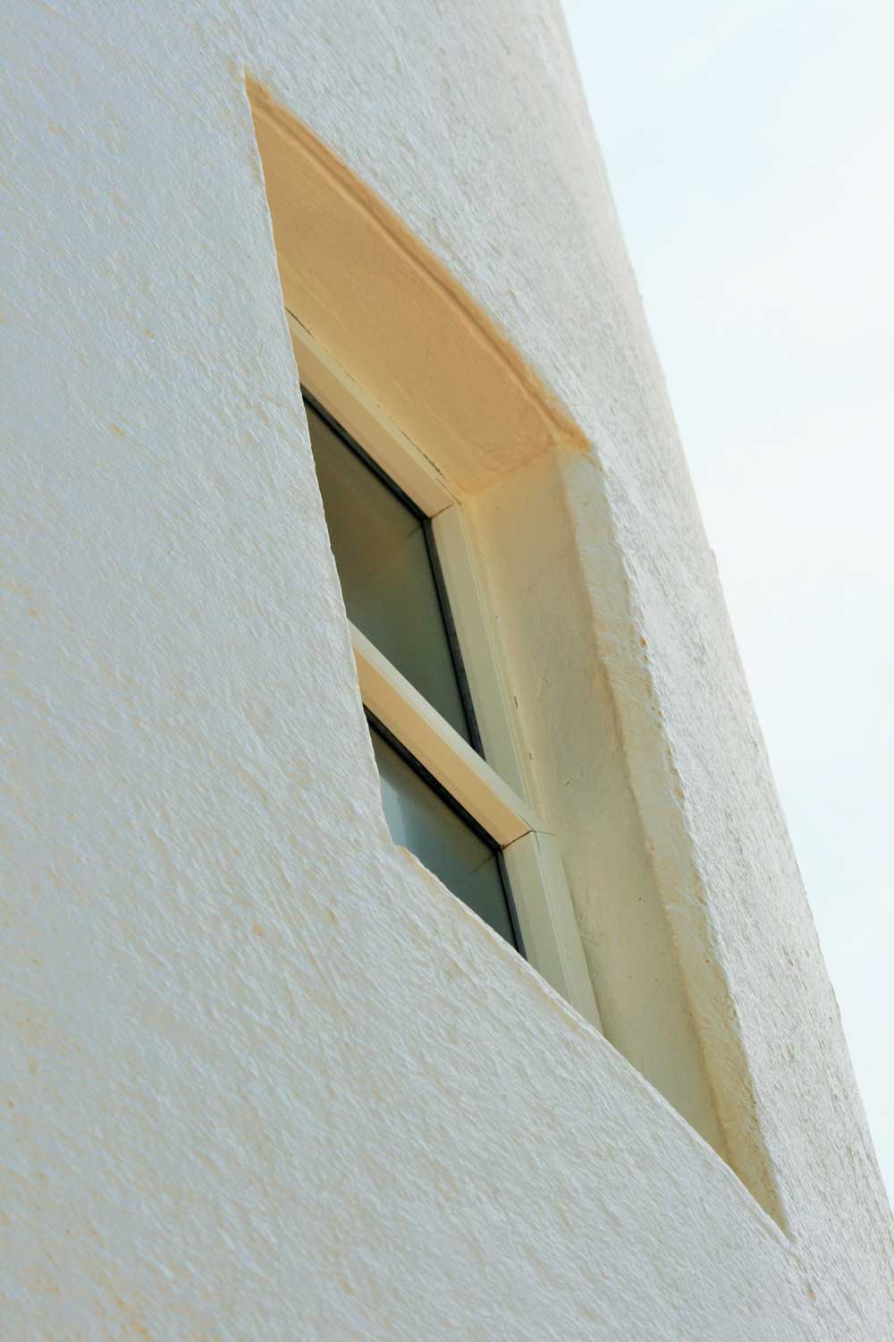 Close-up, angled view of a window on a white building.